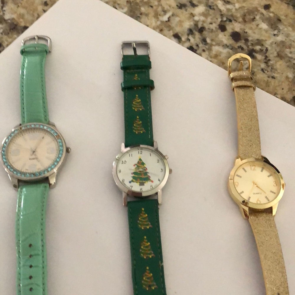 3 watches. 2 green and one gold. All running
